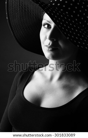 Fashion portrait of elegant woman in black and white hat and black dress - horizotal