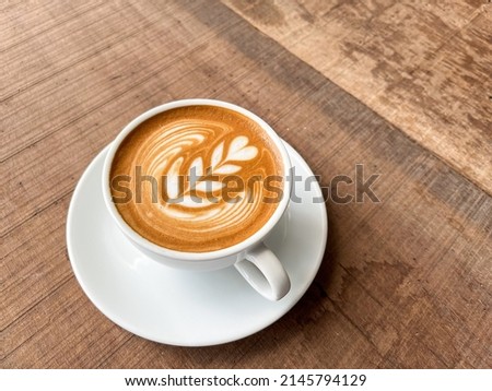 Similar – Image, Stock Photo Cappuccino with latte art on a wooden table in a cafe