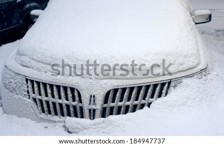 NEW YORK, USA - FEB 16:A Lincoln luxury car buried under layers of snow during severe snow storm on February 16, 2014 in New York, USA