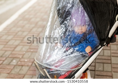 Similar – Image, Stock Photo Stroller in the rain with umbrella