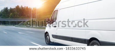 White modern delivery small shipment cargo courier van moving fast on motorway road to city urban suburb. Busines distribution and logistics express service. Mini bus driving on highway day. banner