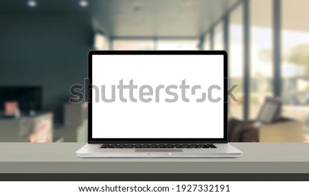Laptop or notebook with blank screen on service counter in blurry background with parcel delivery office express, EMS.