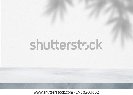 marble table with leaf tree bamboo shadow on concrete wall for texture background. product display, mockup.