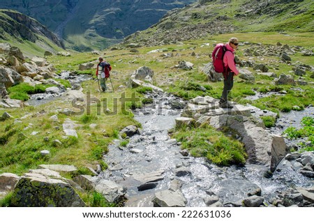 PYRENEES, SPAIN - CIRCA JULY, 2012 - Two girl walking in the Spanish Pyrenees (GR11 trail).  D.Two girls walking in the Spanish Pyrenees.