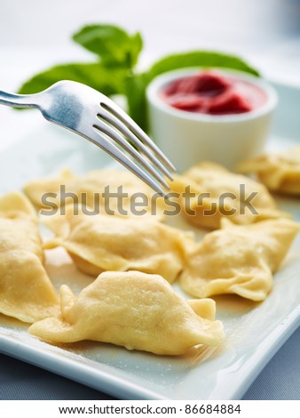 tasty fruit dumplings with cheese and sauce