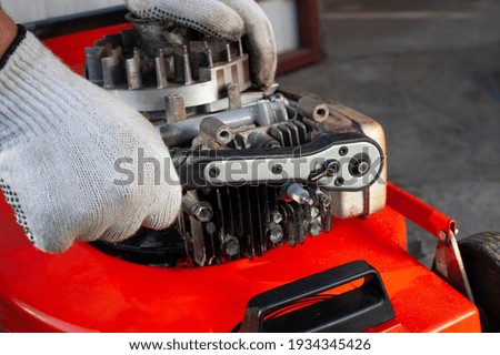 Similar – Image, Stock Photo Repairman fixing old broken motorcycle in workshop