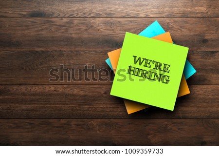 We're Hiring, the phrase is written on multi-colored stickers, on a brown wooden background. Business concept, strategy, plan, planning. Foto stock © 