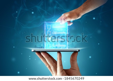 Online voting, Hand with a hologram ballot and a box for Internet voting in a mobile phone on a blue background. Mixed environment, e-voting technology concept