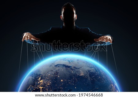 A man, a puppeteer, manipulates the planet. The concept of world conspiracy, world government, manipulation, world control