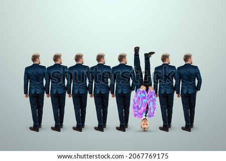 Uniqueness creative background, among the crowd of businessmen a man stands upside down. Competitive advantage, standing out from the crowd, thinking outside the box, a leader Photo stock © 