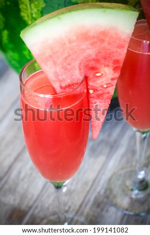 Watermelon Bellini Cocktail in Champagne glass with watermelon chunk on the glass
