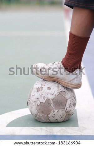 old football , holding football , old shoe