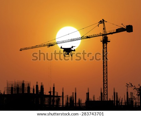 Construction Site and drone silhouette in the sunset background