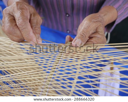 old woman crafts bamboo