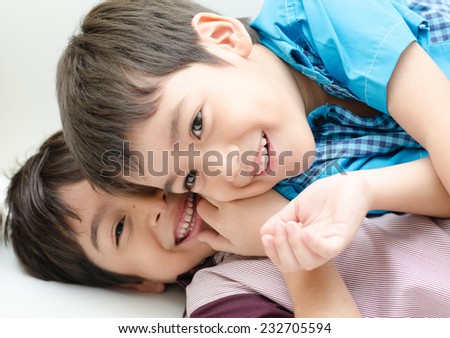 Little sibling boy fighting on sofa