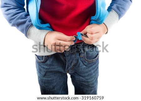Little boy trying cloth his zipper on sweater