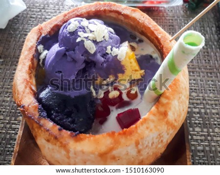 Famous halo halo or mixed iced from Philippines that you can eat on a coconut husk. Halo-Halo is a famous filipino Dessert usually served during summer. Served on a full coconut husk.