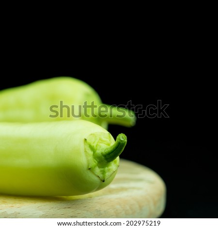 Green pepper vegetables on black background