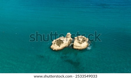 Similar – Image, Stock Photo The Two Sisters stacks in front of the shore of Torre dell’Orso