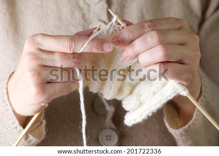 Hands knitting cose-up