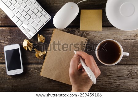 Table with business tools and hand