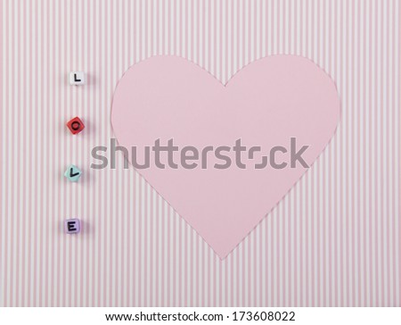pink card with the shape of the heart and the word love from cubes