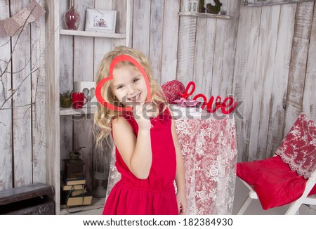 beautiful girl with white hair in a red dress looking up and smiling, through the frame in the form of heart