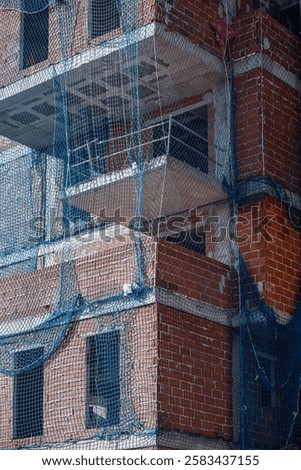 Similar – Image, Stock Photo Scaffolding with protective net and tarpaulin from frog perspective / house renovation