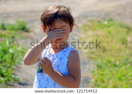 Little girl hiding, to cover eye, to cover oneÃ?Â¢??s face with oneÃ?Â¢??s hands