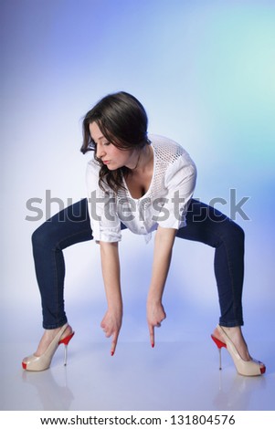 Full body young plus size woman in casual clothes, relaxed pose studio shot blue background