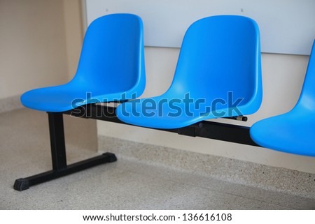 waiting room blue chairs, door on the floor