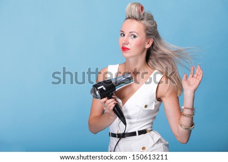 pin up girl retro style portrait woman drying hair with electric fan