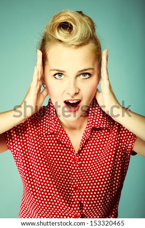 surprised woman face, beautiful girl in retro style holding her head in amazement and open-mouthed blue background