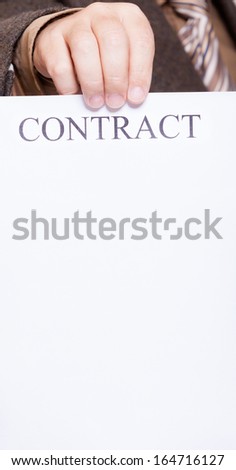 Business concept. Businessman holding blank empty paper sheet with sign contract and space for text.
