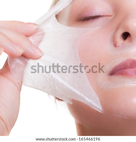 Part of face. Portrait of blond girl young woman in facial peel off mask. Peeling. Beauty and body skin care. Isolated on white background. Studio shot.