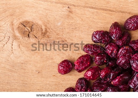 Healthy food organic nutrition. Border frame of dried cranberries cranberry fruit on wooden background