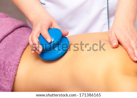 Beauty treatment concept. Woman getting spa therapy cupping glass vacuum massage in salon. Alternative medicine procedure, body care healthy lifestyle.