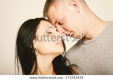 Young couple, face to face, in a loving pose.