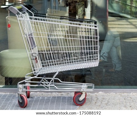 Empty shopping cart trolley. Market grocery shop and retail concept. Outdoor.