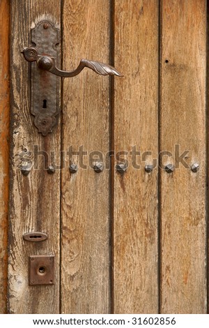Old wooden door. Metallic knob and lock