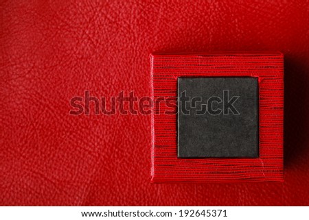 Red black rectangular ring jewellery box on leather background