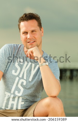 Happiness summer vacation and people concept. Fashion portrait of handsome man on the beach landscape