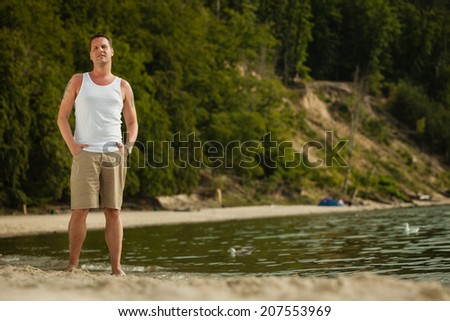 Happiness summer vacation and people concept. Fashion portrait handsome man full length on the beach landscape