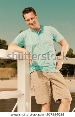 Happiness summer vacation and people concept. Fashion portrait of handsome man on pier