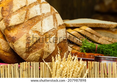 many rustic baked traditional rye bread loaves on a market stall outdoor