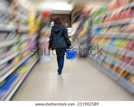 Woman grocery shopping at the supermarket, female customer is choosing food