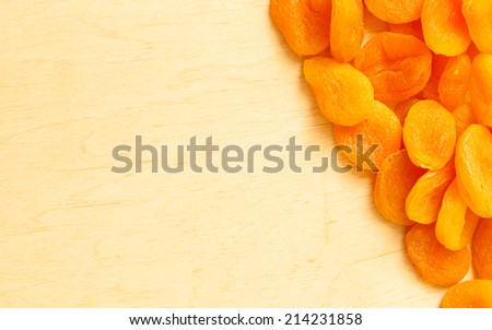 Healthy food organic nutrition. Border frame of dried apricots set fruit on wooden background