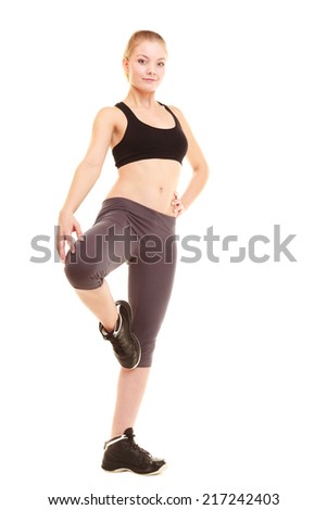 sport and active life. fitness sporty blonde girl young woman in sportswear stretching her leg isolated on white.
