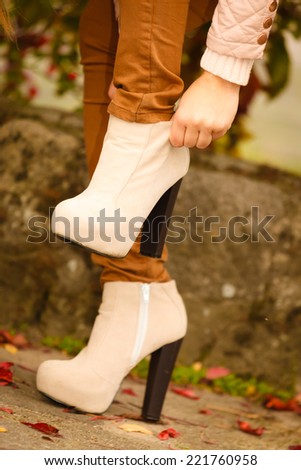 Autumn fashion. Female legs foots in stylish fashionable shoes boots outdoor
