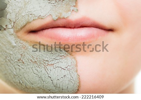 Skin care. Woman in clay mud mask on face isolated on white. Girl taking care of dry complexion. Beauty treatment.